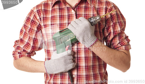 Image of hands handling an electric drilling machine