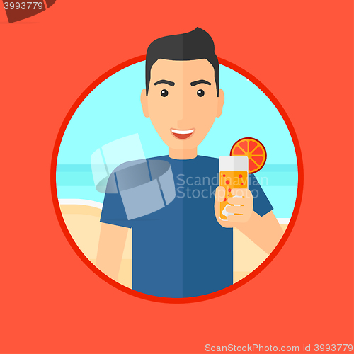 Image of Man with cocktail on the beach.