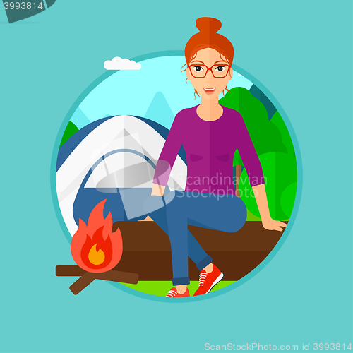 Image of Woman sitting on log in the camping.