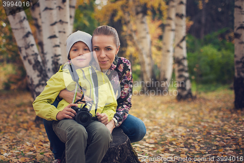 Image of Woman and her son with camera