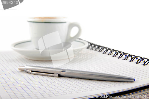 Image of blank page, empty cup of coffe, pen