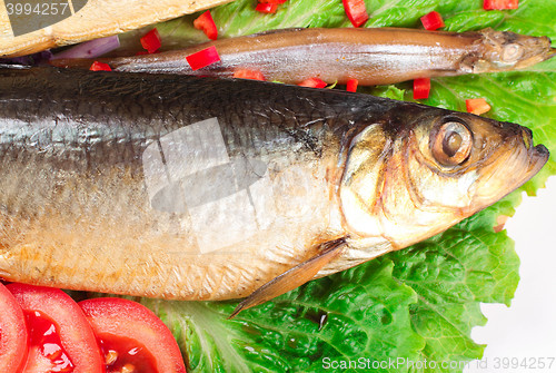 Image of fish on plate with red pepper