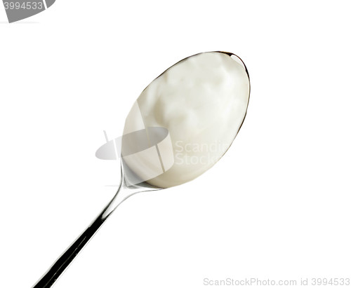 Image of Spoon of yogurt isolated on white