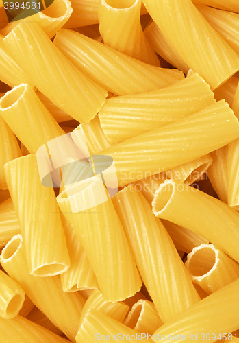 Image of Closeup of uncooked wholewheat italian pasta - penne