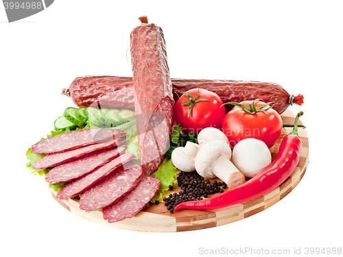 Image of sliced sausage with vegetables and red papper