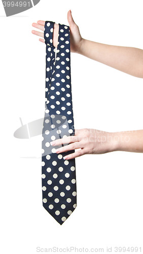 Image of woman holding polka dot tie