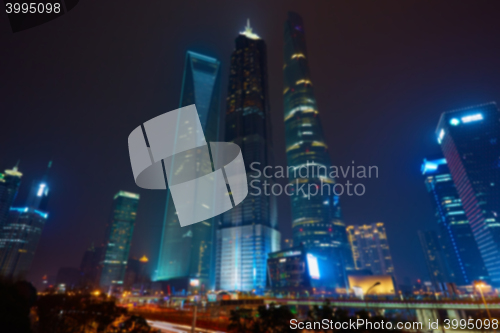 Image of Shanghai skyline at night out of focus.