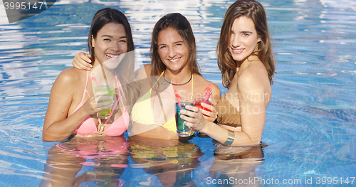 Image of Three happy sexy female friends in a pool