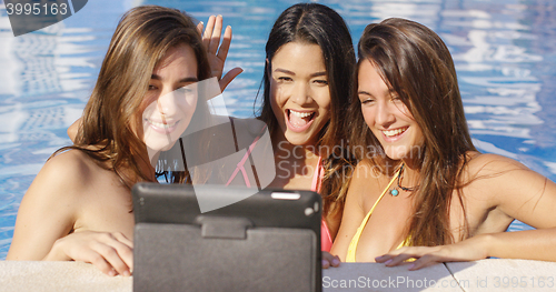 Image of Three vivacious smiling women taking a selfie