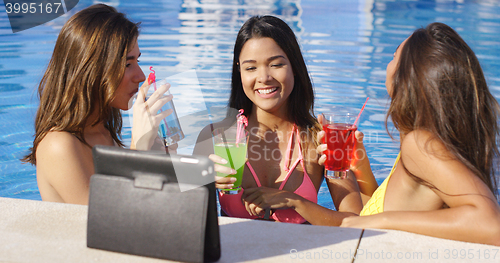 Image of Three young women having fun taking selfies