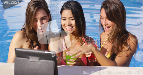 Image of Three young women having fun taking selfies