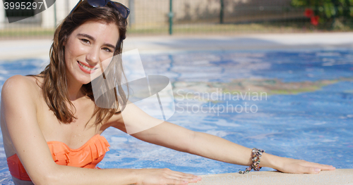 Image of Attractive trendy young woman in a swimming pool