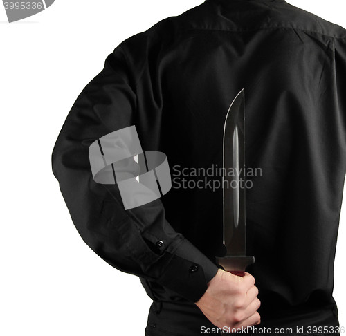 Image of standing man in black with knife for backs