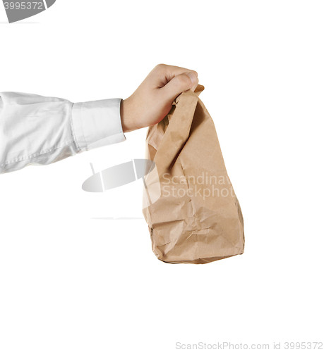 Image of Man holding a brown paper bag in his hand