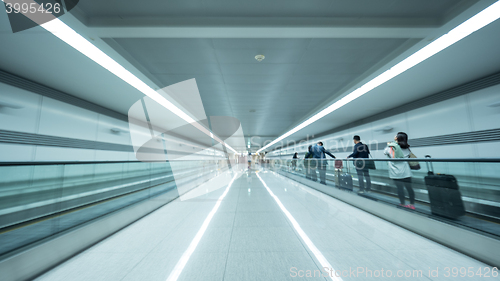 Image of Tunnel at Seoul airport with people on flat escalator