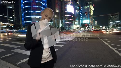 Image of Woman with tablet PC in night Seoul, South Korea