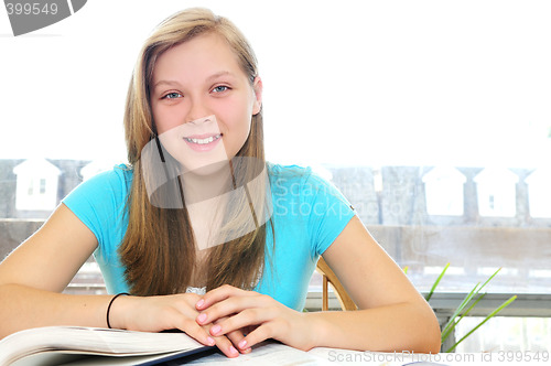 Image of Happy teenage girl studying