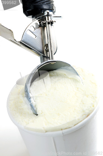 Image of Tub of vanilla ice cream with a scoop