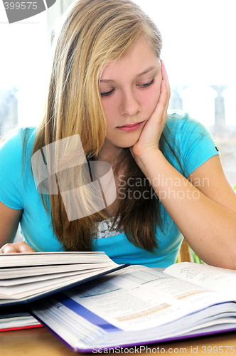 Image of Teenage girl studying with textbooks