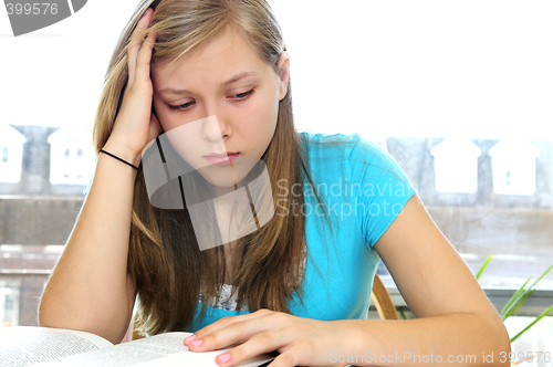 Image of Teenage girl studying with textbooks