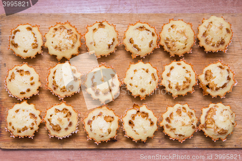 Image of Top view of eighteen freshly baked muffins stuffed with boiled condensed milk