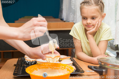 Image of My daughter looks like mom prepares the blank for baking Easter cakes