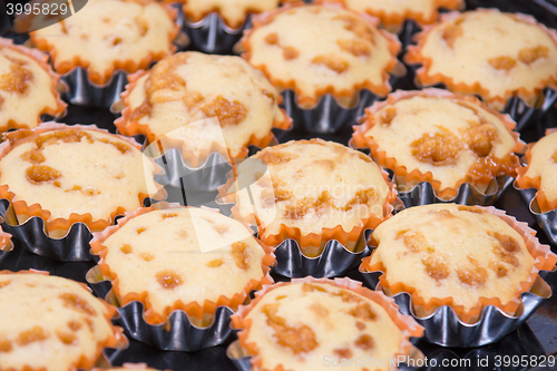 Image of A view of several freshly baked cakes in metal tins