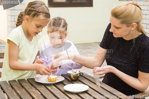 Image of Mother and two daughters sprinkled cupcakes Easter candy sprinkles