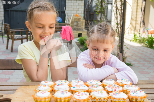 Image of Two sisters with an appetite for looking at home-baked Easter cakes