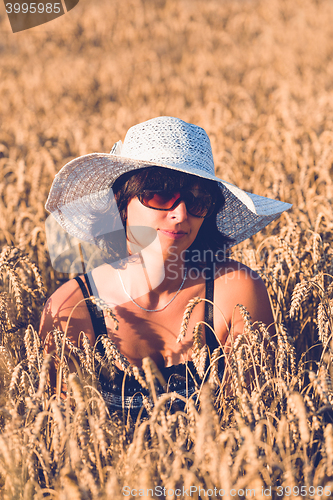 Image of Middle aged beauty woman in wheat field