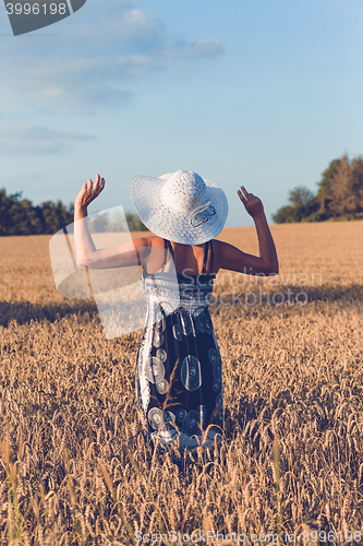 Image of Middle aged beauty woman in wheat field