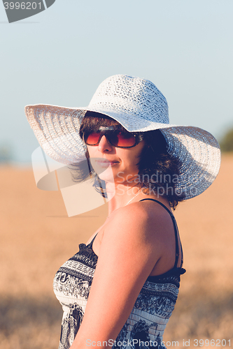 Image of Middle aged beauty woman in wheat field