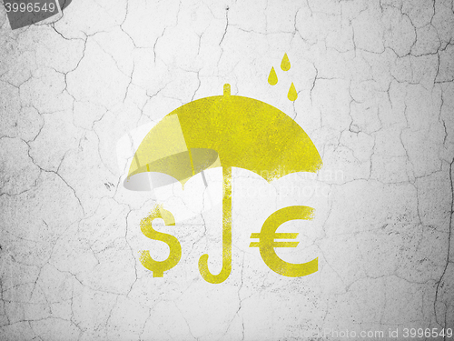 Image of Safety concept: Money And Umbrella on wall background