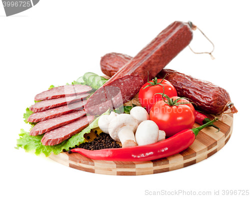 Image of sliced sausage with vegetables and red papper
