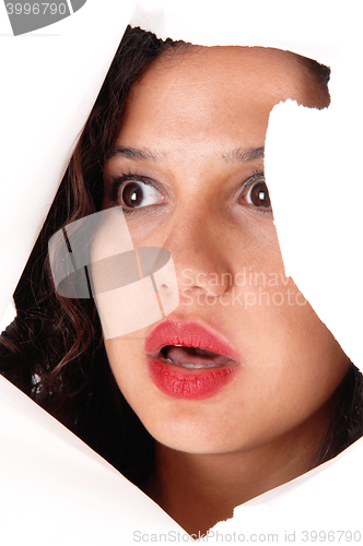 Image of Woman looking through hole in paper.