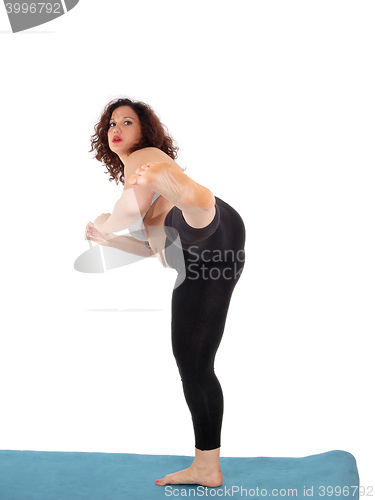 Image of Woman kicking with her leg.