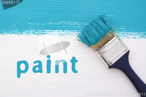 Image of Stripe of turquoise paint, paintbrush and the word PAINT