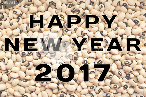 Image of Happy New Year 2017 text over black eyed peas