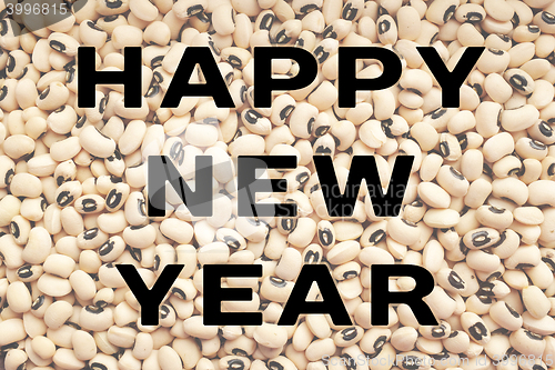 Image of Happy New Year text over black eyed peas
