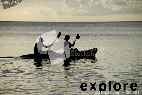 Image of Kayakers silhouetted on the ocean, EXPLORE as concept text