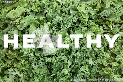 Image of HEALTHY text over shredded kale leaves background