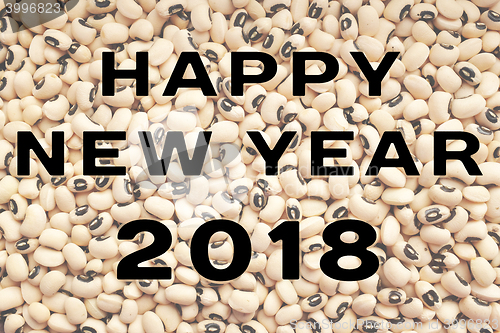 Image of Happy New Year 2018 text over black eyed peas