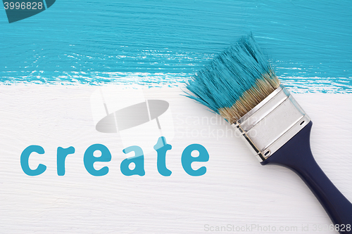 Image of Stripe of turquoise paint, paintbrush and the word CREATE