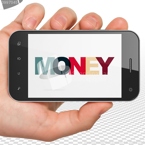 Image of Business concept: Hand Holding Smartphone with Money on  display