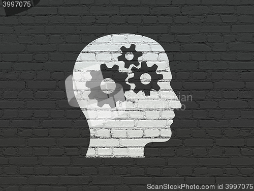 Image of Advertising concept: Head With Gears on wall background