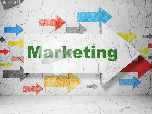 Image of Advertising concept: arrow with Marketing on grunge wall background