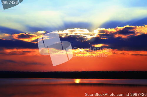 Image of Sunrise over the lake early in the morning with beautiful clouds