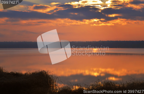 Image of Sunrise over the lake early in the morning with beautiful clouds