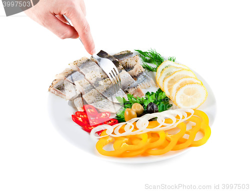 Image of fish on plate with vegetables