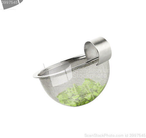 Image of Tea strainer loaded with green tea